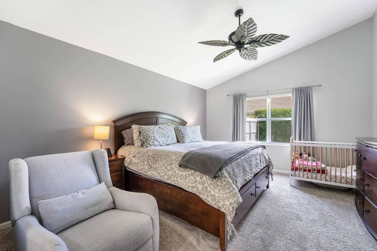 Primary bedroom at 3907 Palladium View Drive with vaulted ceiling and a window to the side yard
